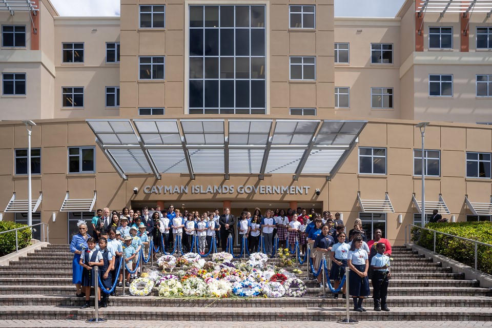Students gather at Government Administration Building to leave flowers